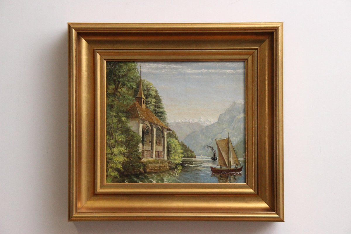 Landskabsmaleri i gylden ramme.