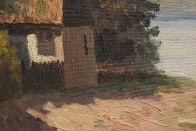 Maleri af ''house by the lake'' i gylden ramme.
