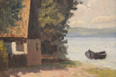 Maleri af ''house by the lake'' i gylden ramme.